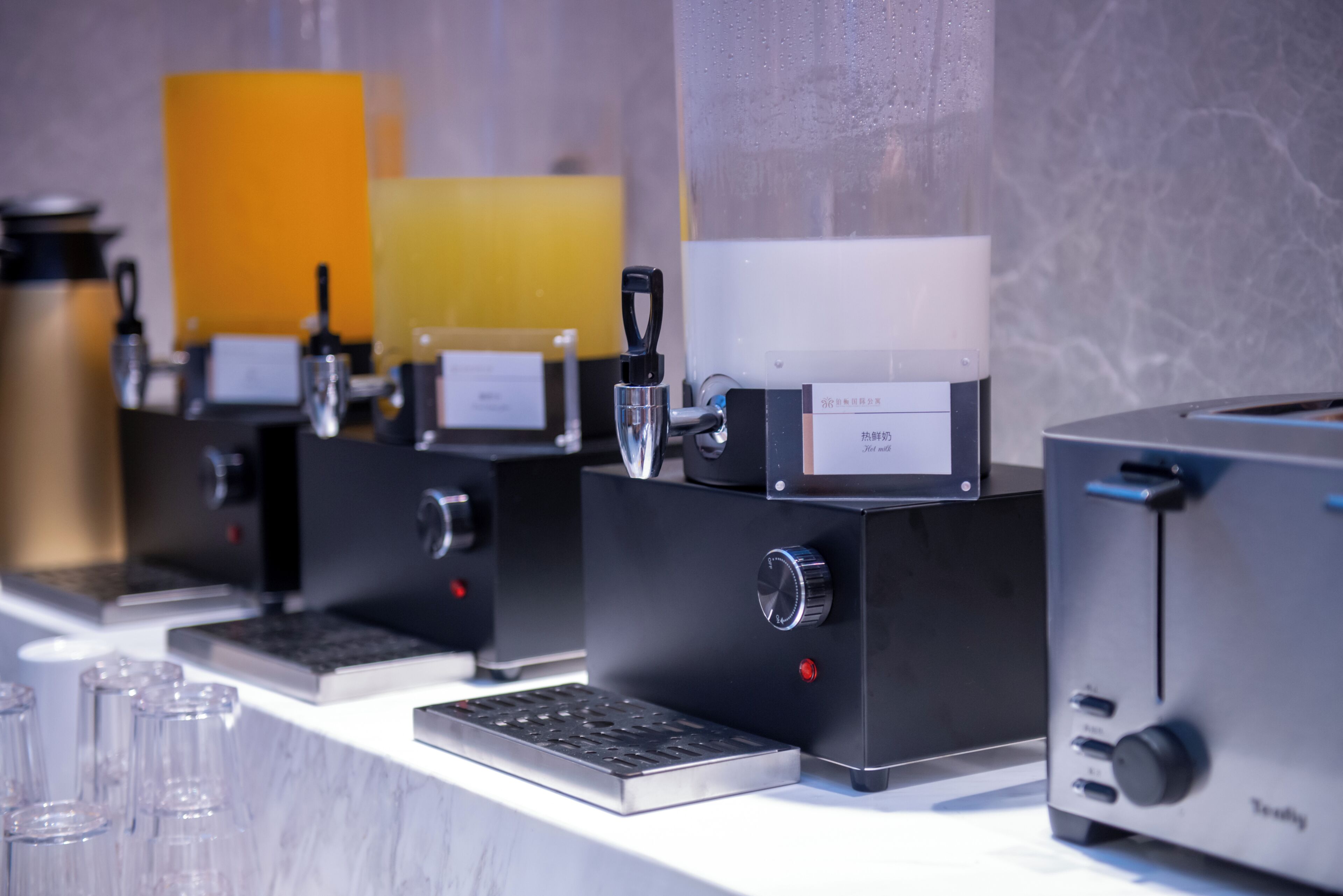 A coffee machine setup with a digital display, a control panel, and a coffee dispenser.