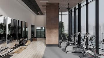 A modern gym with exercise equipment, large windows, and a city view.