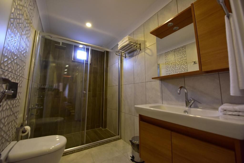 Shower, hair dryer, slippers, towels