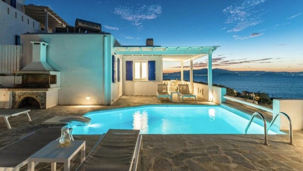A pool area with a covered seating area, stone flooring, and a view of the sea. - Virelian Studio, Divine Sea Views, Furnished Terrace, Naxos (Plaka)