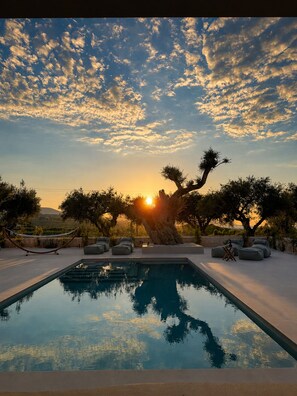 A pool with a sunset view, outdoor seating, and trees. - Conte Maris Tower III - Sea View Mediterranean Escape (Tragaki)