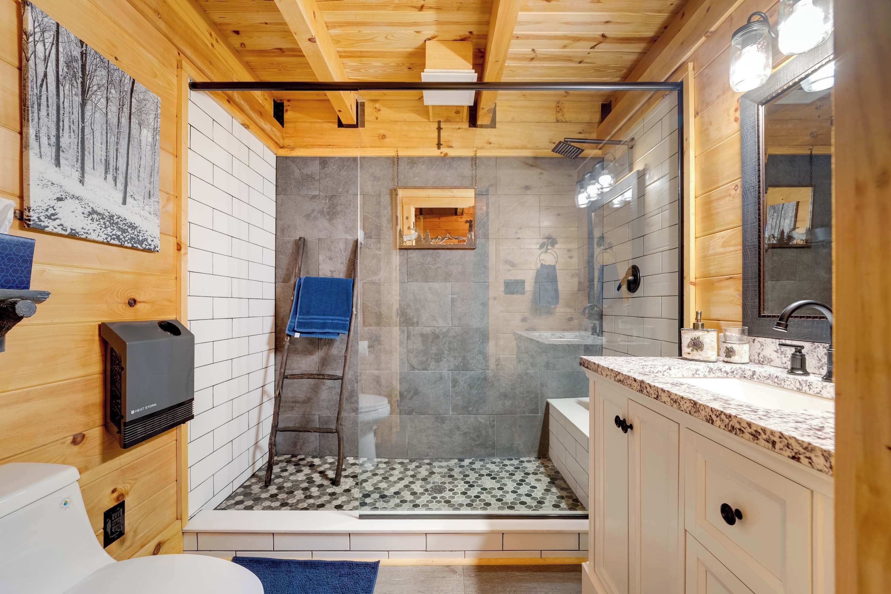 A modern bathroom with a shower, toilet, and sink.