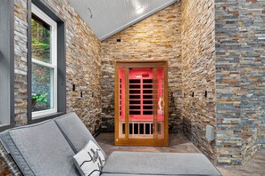 A room with a stone wall, a wooden door, and a window. - Sleeps 27 • Pool + Hot Tub + Theater + Near Pigeon Forge | It’s Got It All Y’all (Pigeon Forge)