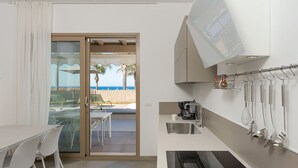 A compact kitchen with a built-in oven, a coffee maker, and a sink. - Splendid sea-view villa in Marzamemi, Di Casa In Sicilia (Noto)