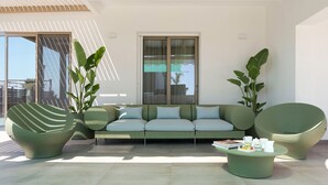 A modern outdoor seating area with a sofa, two chairs, and a coffee table. - Splendid sea-view villa in Marzamemi, Di Casa In Sicilia (Noto)