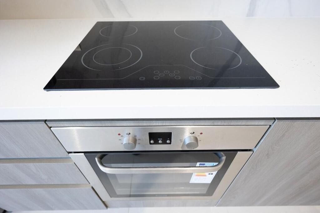 A kitchen with a built-in oven and a stovetop.