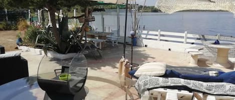 An outdoor patio with a table, chairs, and a large umbrella.