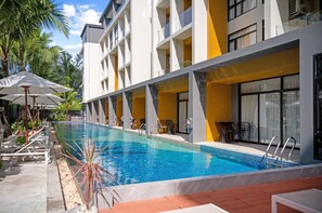 A modern hotel with a swimming pool, outdoor seating, and a tropical garden. - Sea Heaven Naithon Beach by Tropiclook (Thalang District)