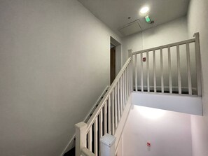 A staircase with white railings and a white wall. - Walk to Everything | Sleeps 4 | 2 Bed | Bold St (Merseyside)
