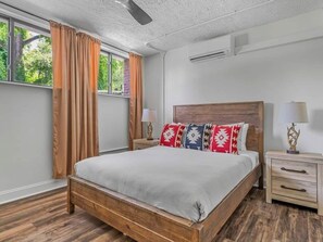 A bedroom with a wooden bed, two bedside tables, a ceiling fan, and a window with curtains. - Sabel #002 | Asheville Queen Suite w/ Kitchenette Near Downtown & Biltmore (Asheville)