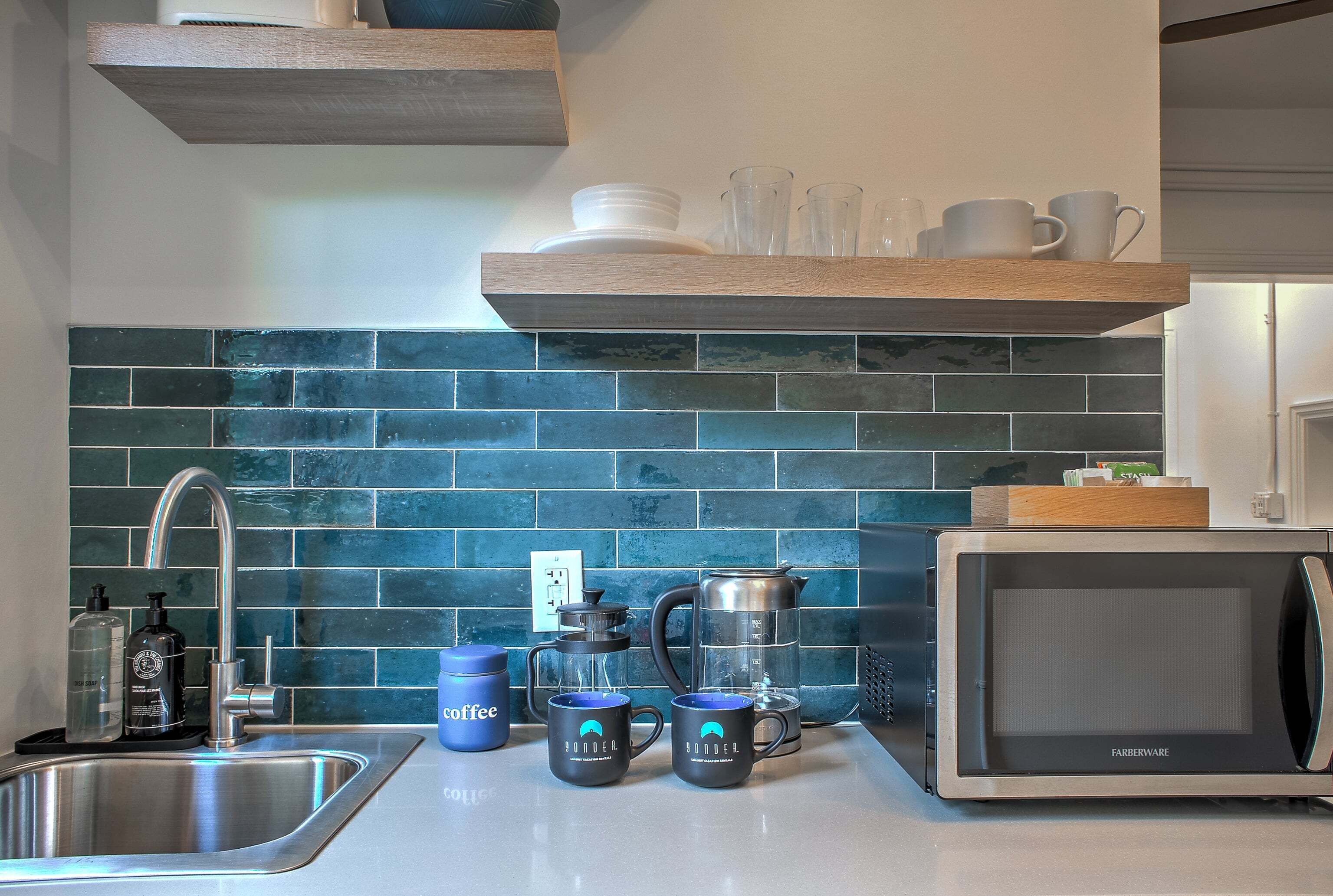 Coffee/tea maker, microwave, cookware/dishes/utensils, dining table