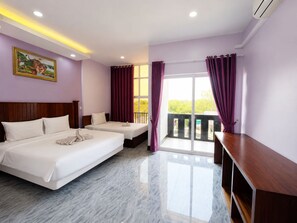 A hotel room with two beds, a wooden headboard, a painting on the wall, and a balcony with curtains.