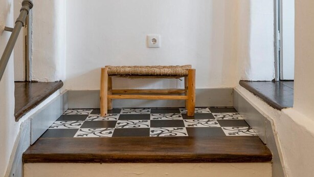 A staircase with a wooden bench, a framed picture, and a light fixture. - Apartment 'Dazzling House Alentejo' with Private Terrace, Wi-Fi and Air Conditioning (Reguengos de Monsaraz)