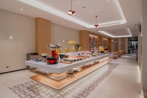 A modern buffet setup with a variety of food items and a long serving counter. - Home Inn Selected (Shanghai)