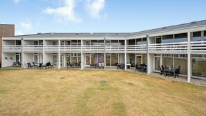A modern building with multiple balconies and outdoor seating areas. - Bright and newly renovated holiday apartment close to the North Sea and. (Ringkøbing)