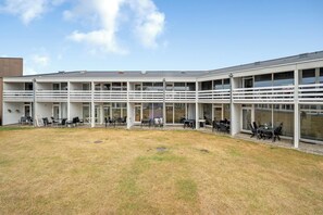 A modern building with multiple balconies and outdoor seating areas. - Bright and newly renovated holiday apartment close to the North Sea and. (Ringkøbing)