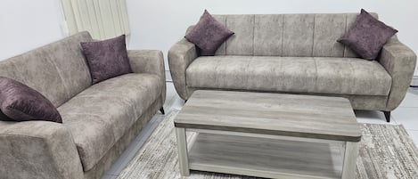 A living room with two sofas and a coffee table.