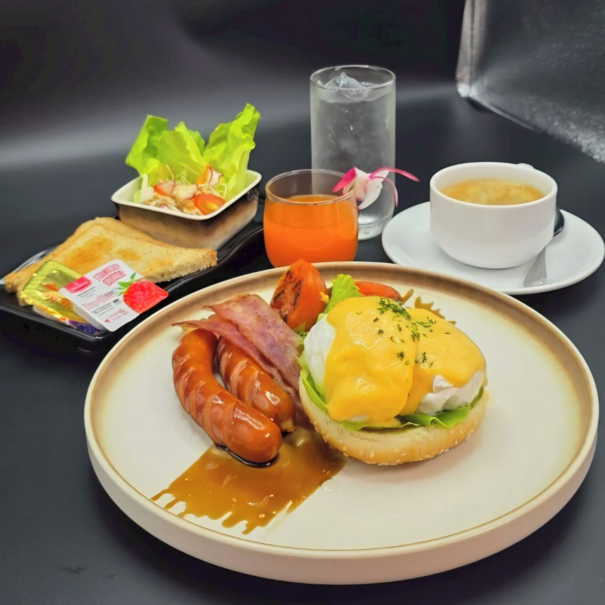 A breakfast plate with sausage, eggs, and toast.