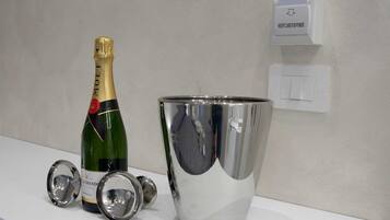 A bottle of champagne, a metallic bucket, and a wall-mounted card reader.