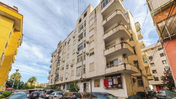A multi-story residential building with balconies, parked cars, and a clear sky. - Sea & Stay Studio | Durrës Waterfront by PikHost (Durrës)