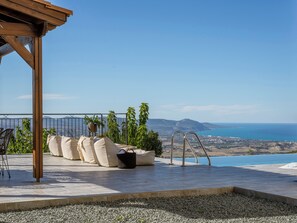 A terrace with a view of the sea, a pergola, and outdoor seating. - Sea-view Retreat - Villas With Private Pools (Peristerona)