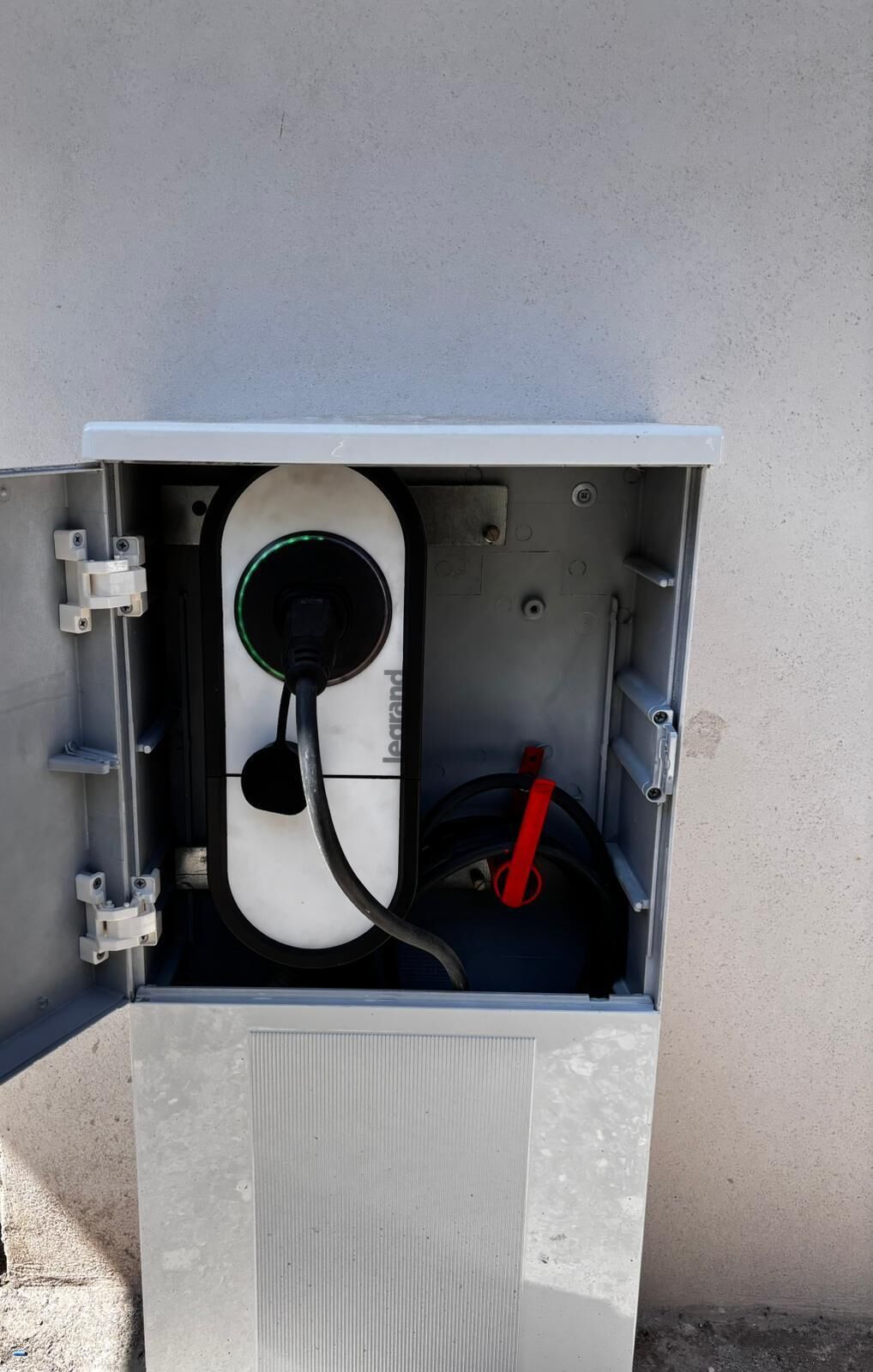 An electrical box with a cable and a plug inside.