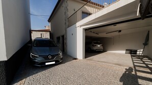 A car parked in a garage with a balcony above. - Casa de Xisto - Uva Douro Houses (Ervedosa do Douro)
