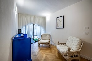 A room with a blue cabinet, a wooden chair, and a sofa. - Bolognese 4 (Florence)