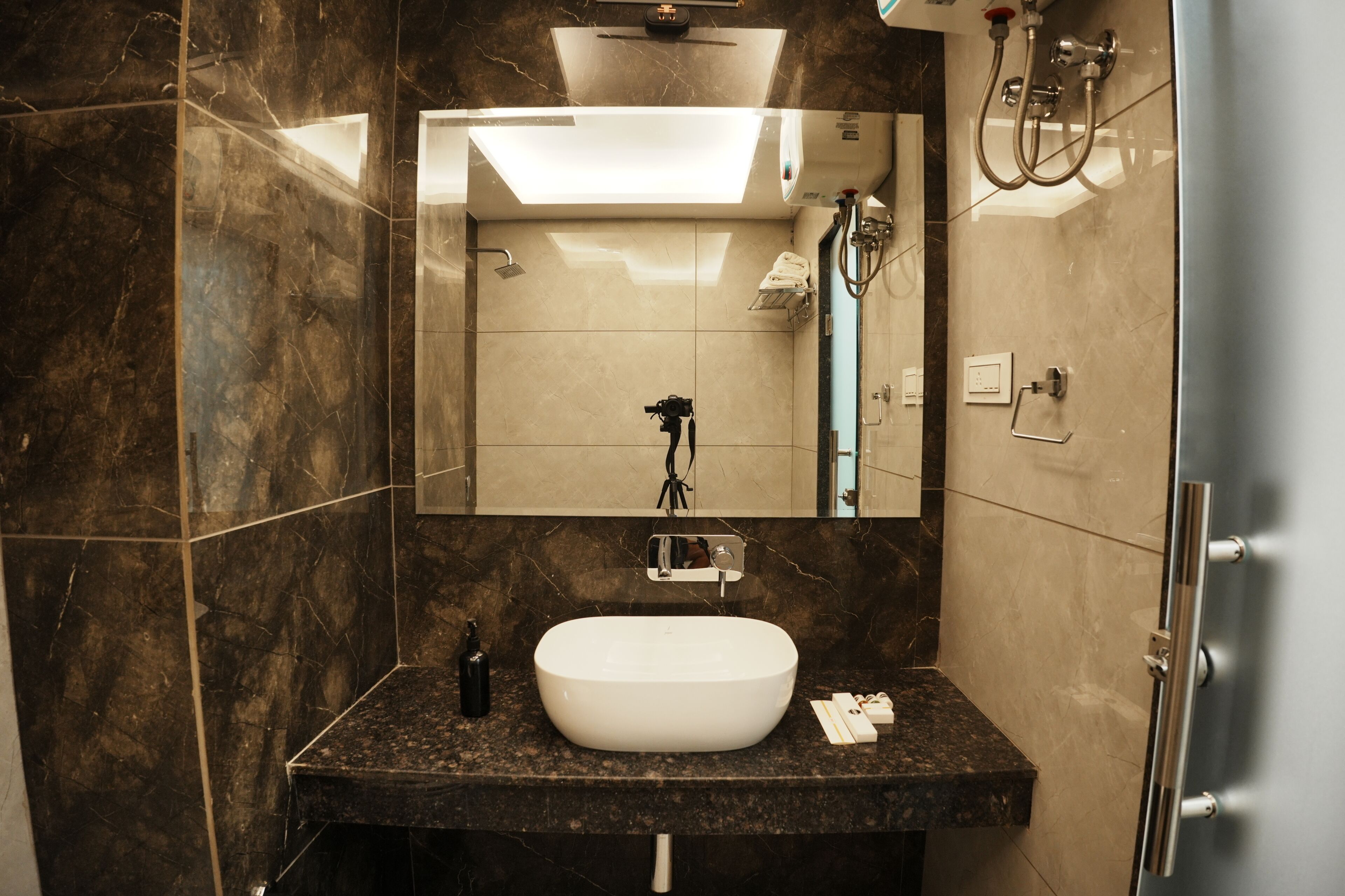 A bathroom with a white sink, a mirror, and a shower.