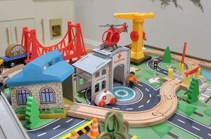 A toy cityscape with a hospital, a red bridge, and a helicopter.