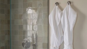 A glass shower enclosure with a metallic handle and a white towel rack with two towels. - Cozy Queen, The Kodrian (Athens)
