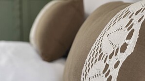 A close-up of a pillow with a white lace cover. - Cozy Queen, The Kodrian (Athens)