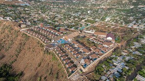 A residential area with multiple houses and a large building with a swimming pool. - Kuriftu Resort & Spa Arba Minch  (Arba Minch)