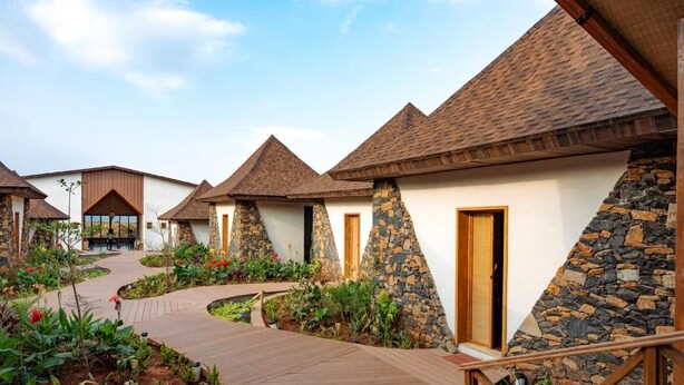 A row of cottages with stone walls and pitched roofs, connected by a wooden pathway. - Kuriftu Resort & Spa Arba Minch  (Arba Minch)
