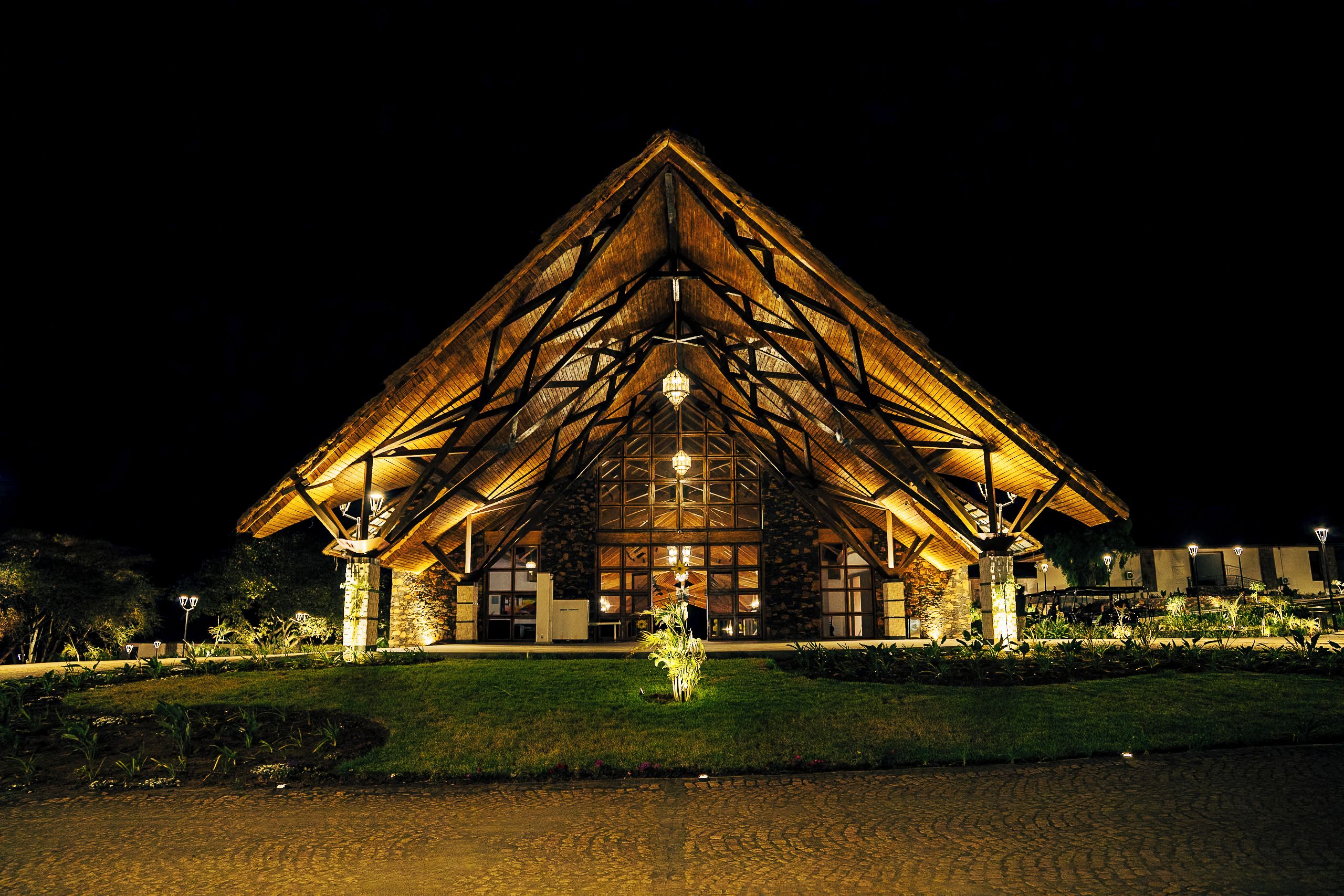 A large, triangular-roofed building with a central entrance and multiple windows.