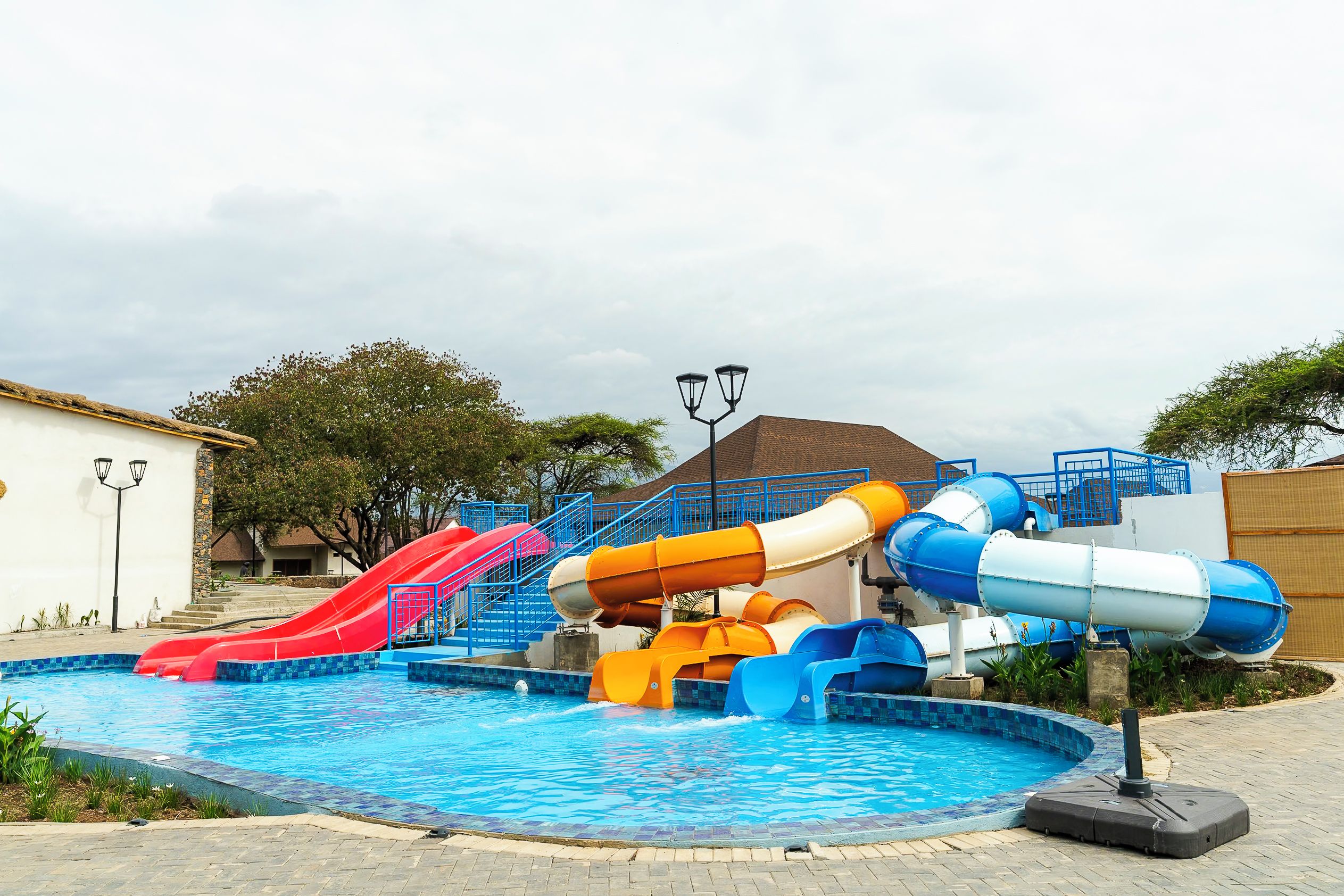 A water park with multiple slides and a swimming pool.