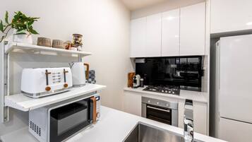 Coffee/tea maker, fridge, microwave, oven