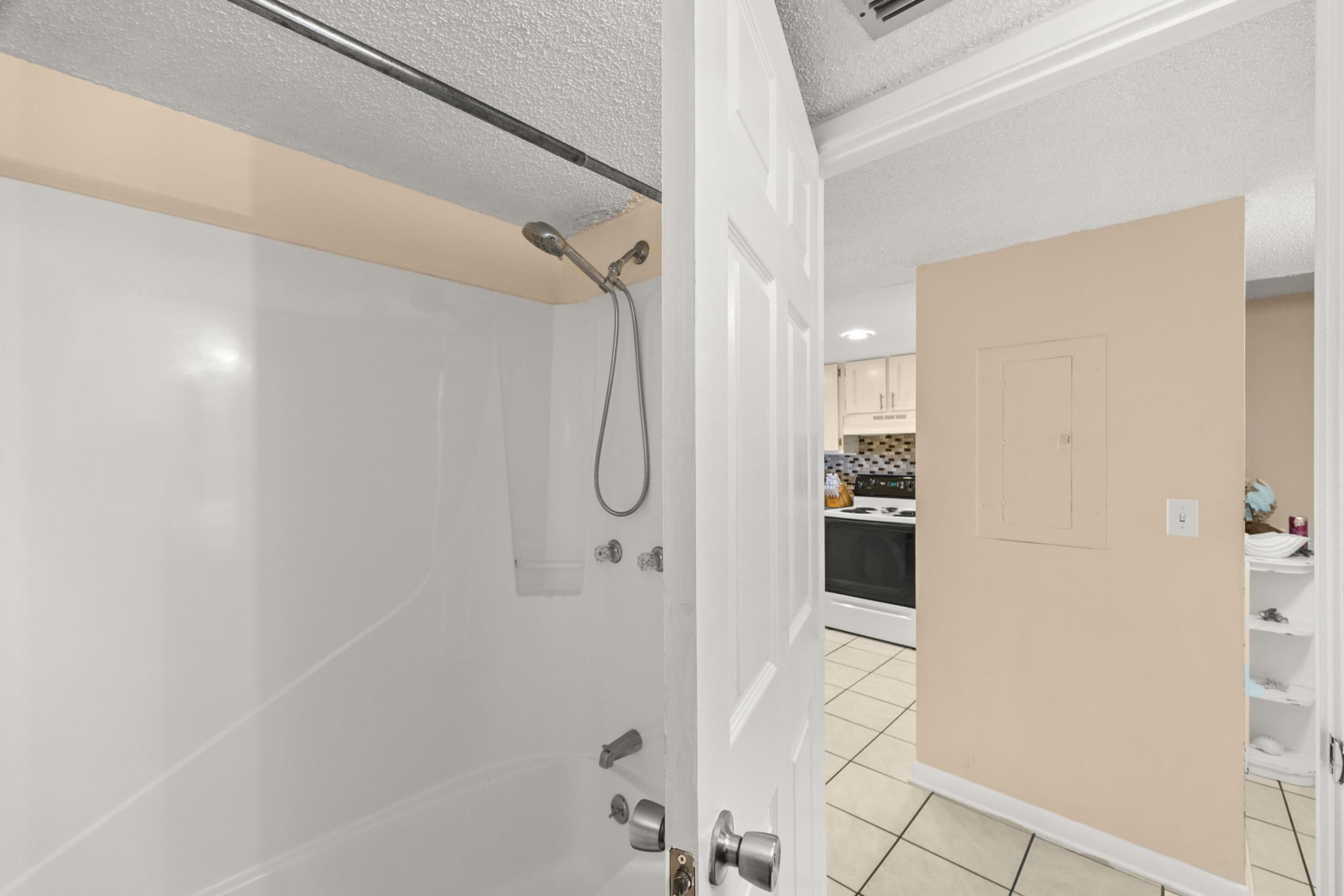 A bathroom with a shower, a toilet, and a sink.