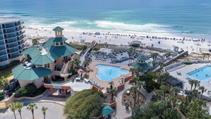A resort with multiple swimming pools, a beach, and a hotel with a distinctive green roof. - 4th-Floor Studio | Walk to Beach | Pool, Beach Tram | Luau II 6421, Sandestin (Miramar Beach)