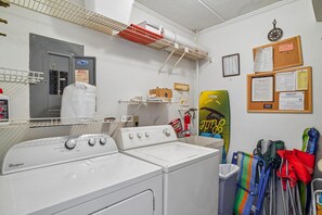 A laundry room with a Whirlpool washer and dryer, a fire extinguisher, and various cleaning supplies. - Includes Xplorie Activities and Linens. Anchorage II 305 on the oceanfront at 130th Street! (Ocean City)