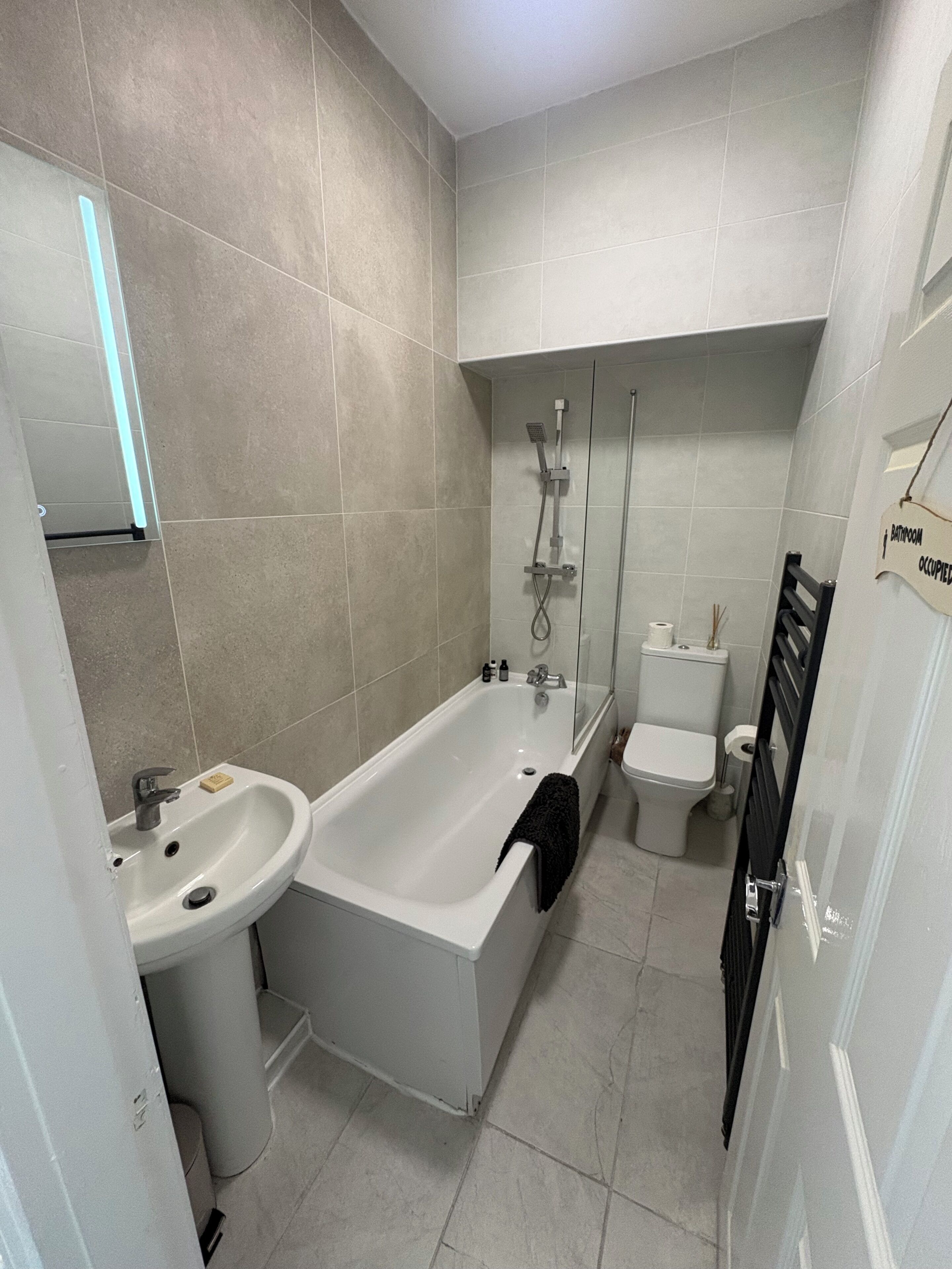 A bathroom with a bathtub, a sink, a toilet, and a shower.