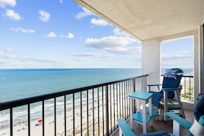 A balcony with a view of the beach and ocean. - Beach Colony Oceanfront 3BR Corner Retreat (Myrtle Beach)