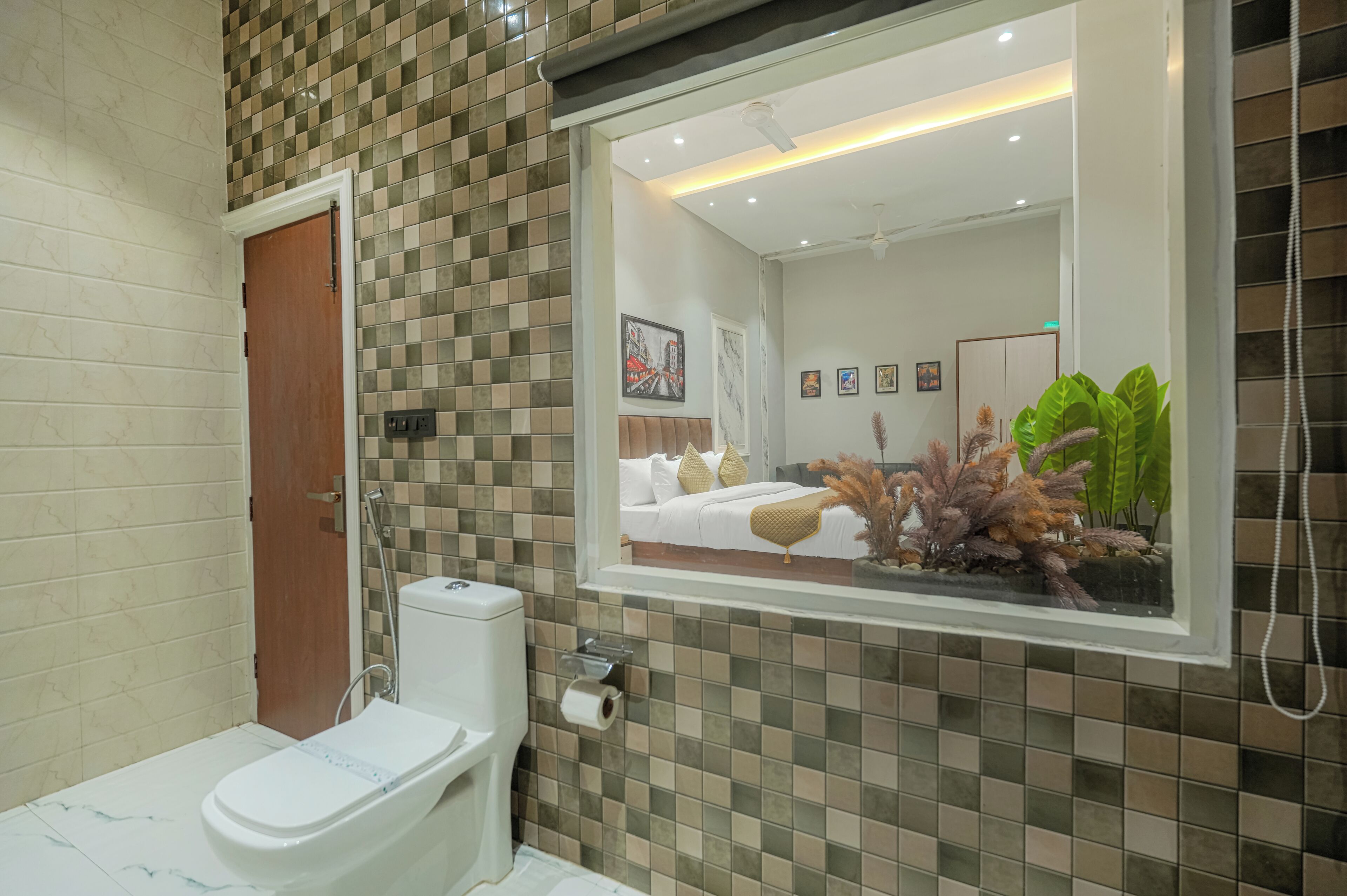 A bathroom with a toilet, a mirror, and a shower.
