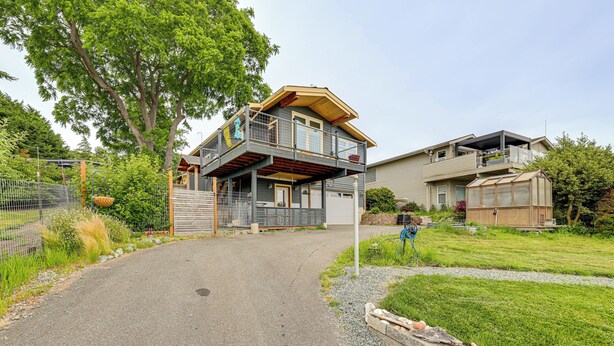 A two-story house with a balcony, a garage, and a small shed. - Hot Tub & Puget Sound View! Whidbey Island Retreat (Clinton)
