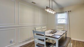 A dining area with a table, chairs, a bench, a chandelier, and a window with curtains. - 4 Mi to Dtwn: Garland Getaway w/ Fenced-in Yard (Garland)