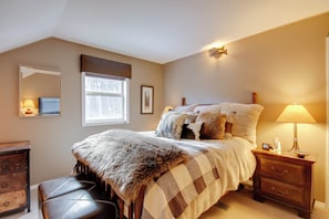 A bedroom with a bed, a nightstand, a dresser, a window, and a mirror. - Great for Families! Woodsy Sanctuary in Mc Leod (McLeod)