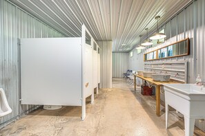 A restroom with a white urinal, a sink, and a mirror. - Family Fun! Bliss Studio w/ Lake & Trail Access (Bliss)
