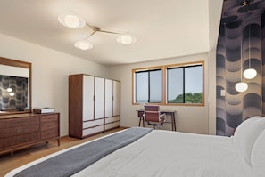 A bedroom with a bed, dresser, desk, and wardrobe. - Unit 35C Lot 8 Oceanhaus (The Sea Ranch)