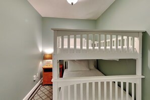 A bunk bed in a room with a single bedside table and a lamp. - Azure #306 | Gulf Front Condo with Stunning Views and Resort Amenities (Fort Walton Beach)