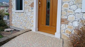 A stone building with a wooden door and a window.